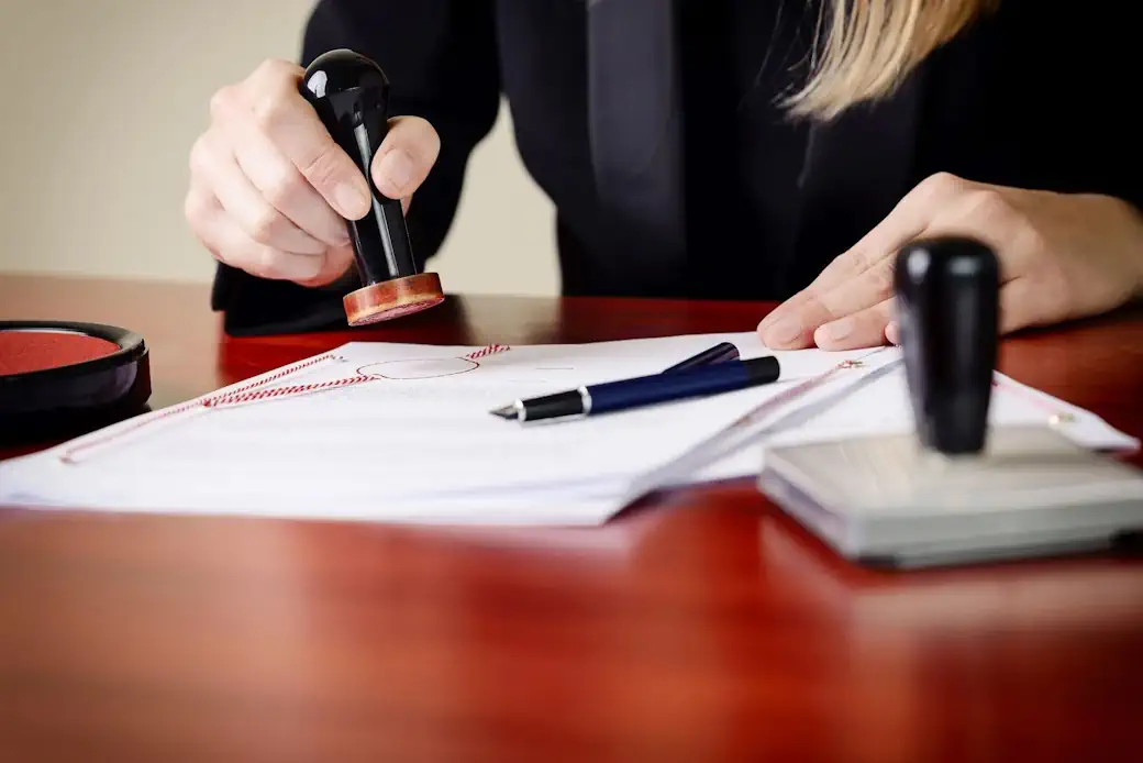 A certified mortgage signing agent guiding clients through an escrow real estate closing package.